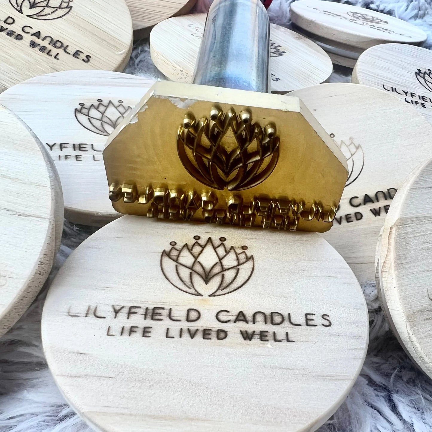 Brass branding stamp imprinting Lilyfield Candles logo on wooden lid, candle packaging