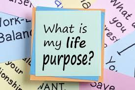 Sticky note with 'What is my life purpose?' on colorful paper background, self-discovery concept.