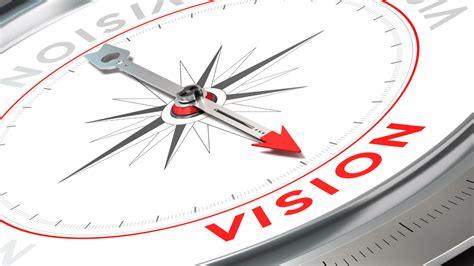 Compass needle pointing to the word vision, symbolizing direction and goals